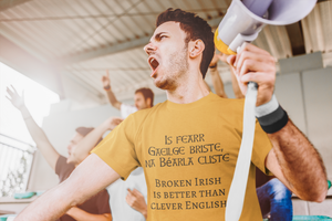 Is fearr Gaeilge briste, ná Béarla cliste - Short-Sleeve Unisex T-Shirt - Leaf, Ash, Gold - Eel & Otter